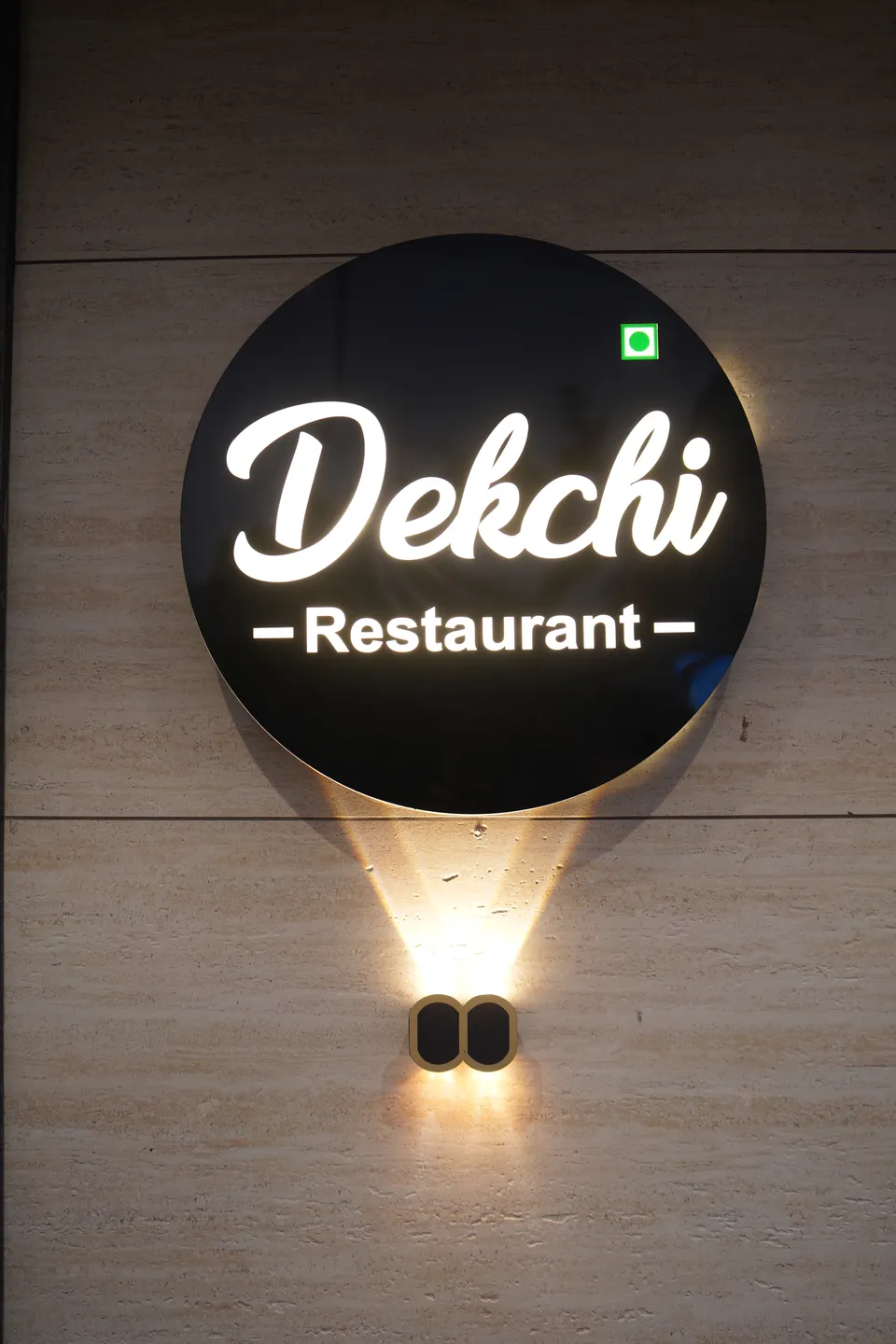 The illuminated Dekchi restaurant sign at Hotel Janki Palace